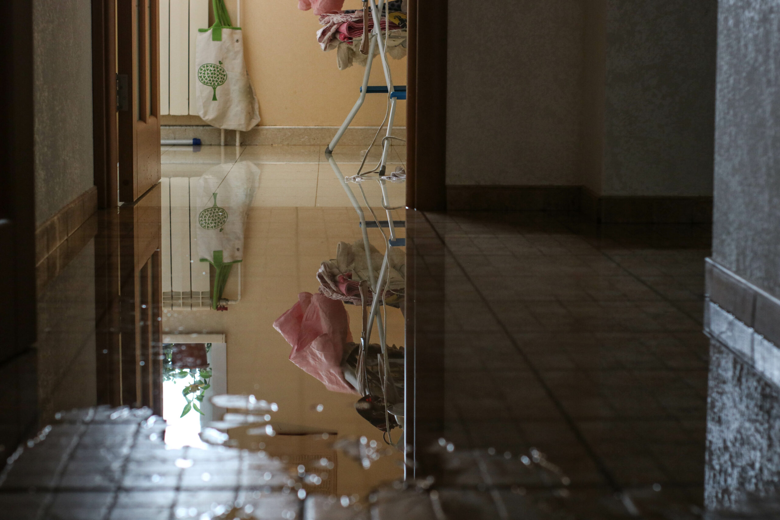 Water damage due a broken pipe. Moisture problem and wet floor. Horizontal, selective focus.