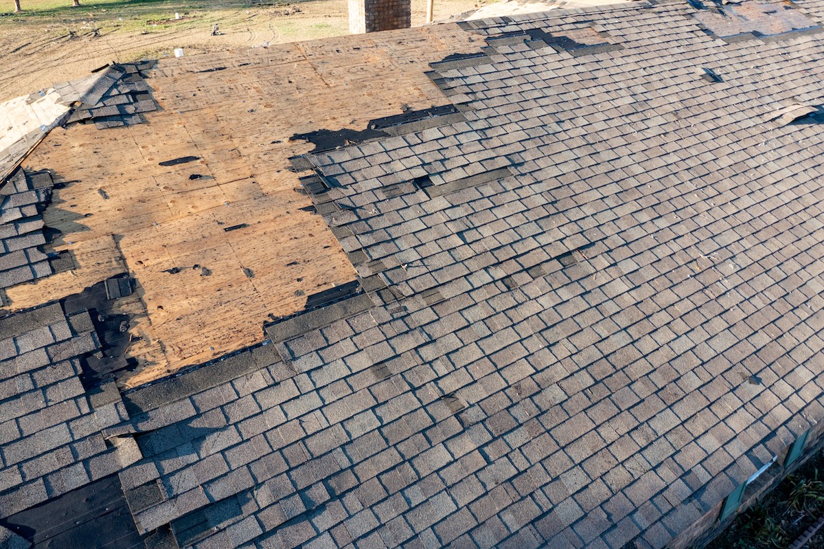 Roof and shingles damaged by tornado during severe weather
